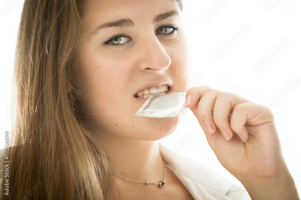 cute brunette woman holding condom in mouth cute brunette woman holding condom in mouth