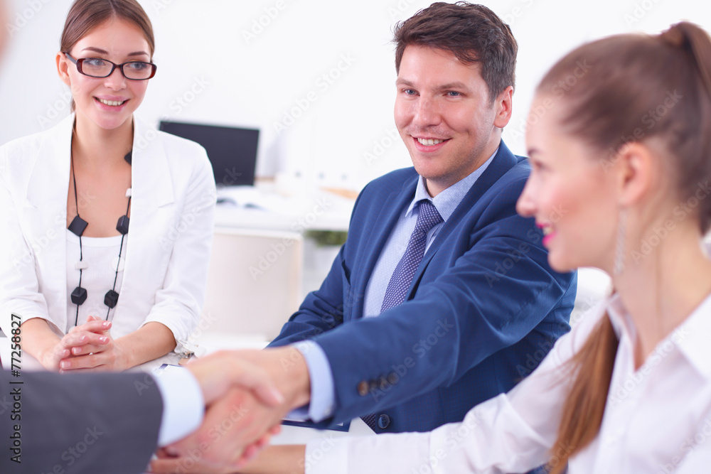 Business people shaking hands, finishing up a meeting Business people shaking hands, finishing up a meeting