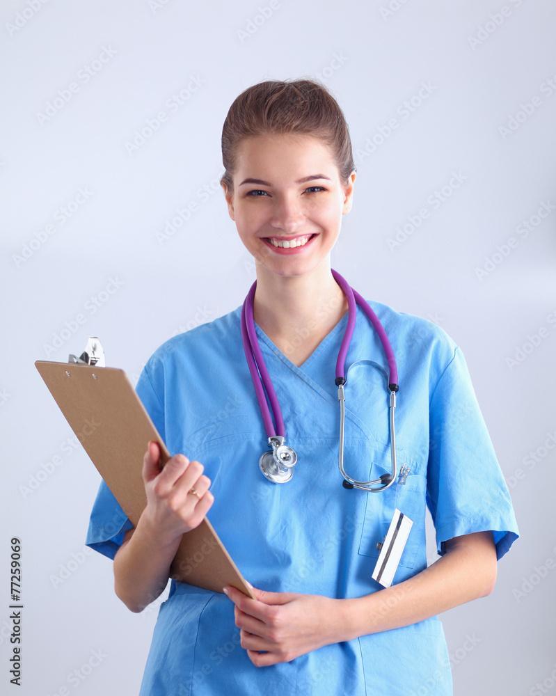 Smiling female doctor with a folder in uniform standing at Smiling female doctor with a folder in uniform standing at