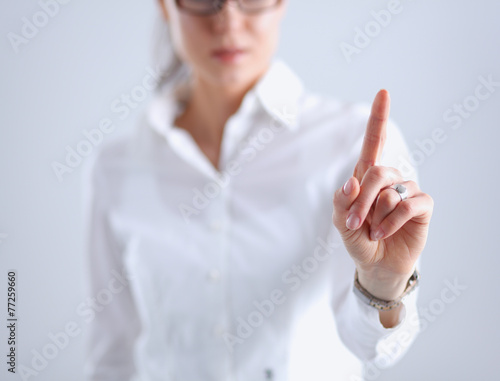 Woman touching an imaginary screen with her finger - isolated