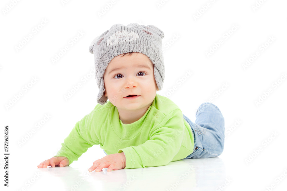 Beautiful baby with wool hat lying on the floor Beautiful baby with wool hat lying on the floor