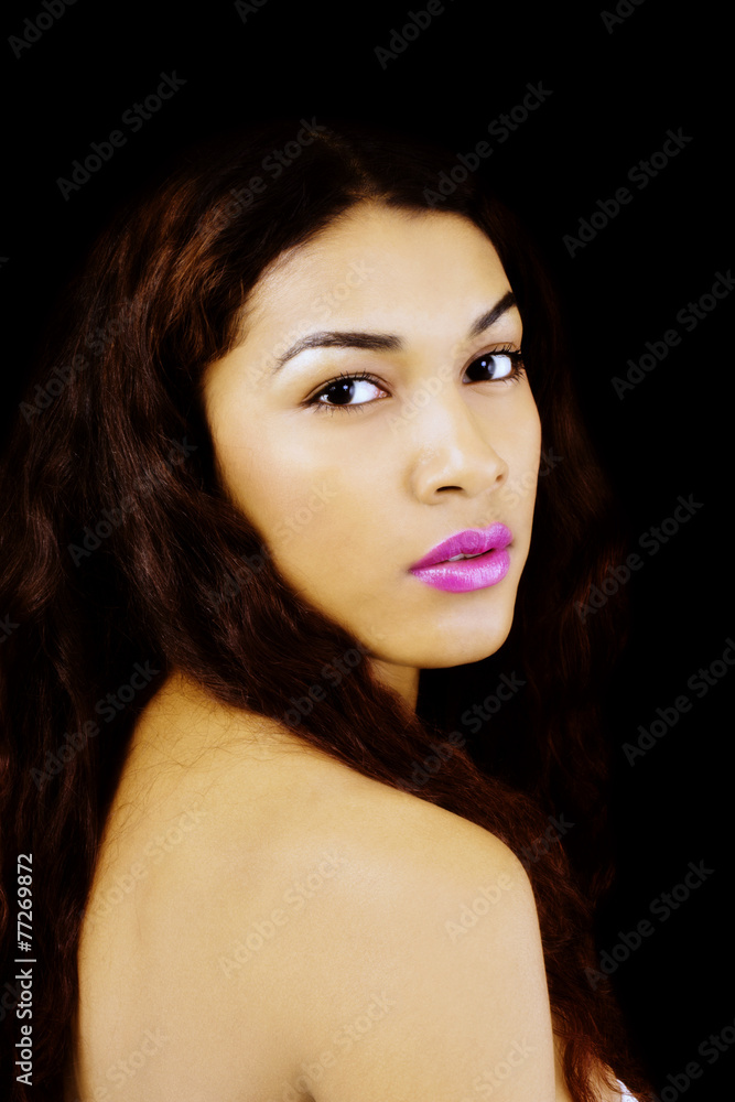 Fototapeta premium Latina Woman Portrait Looking Over Bare Shoulder