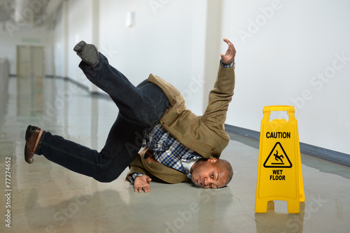 Foto Businessman Falling on Wet Floor