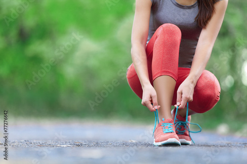 Running shoes - closeup of woman tying shoe laces