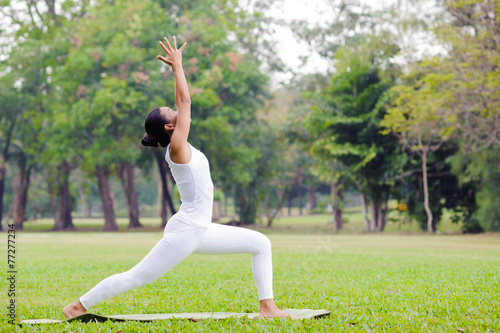 Beautiful woman practicing yoga in the park © TinPong