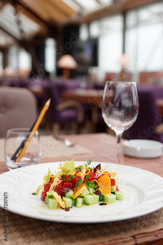 Tuna tartar with cucumber and orange on table
