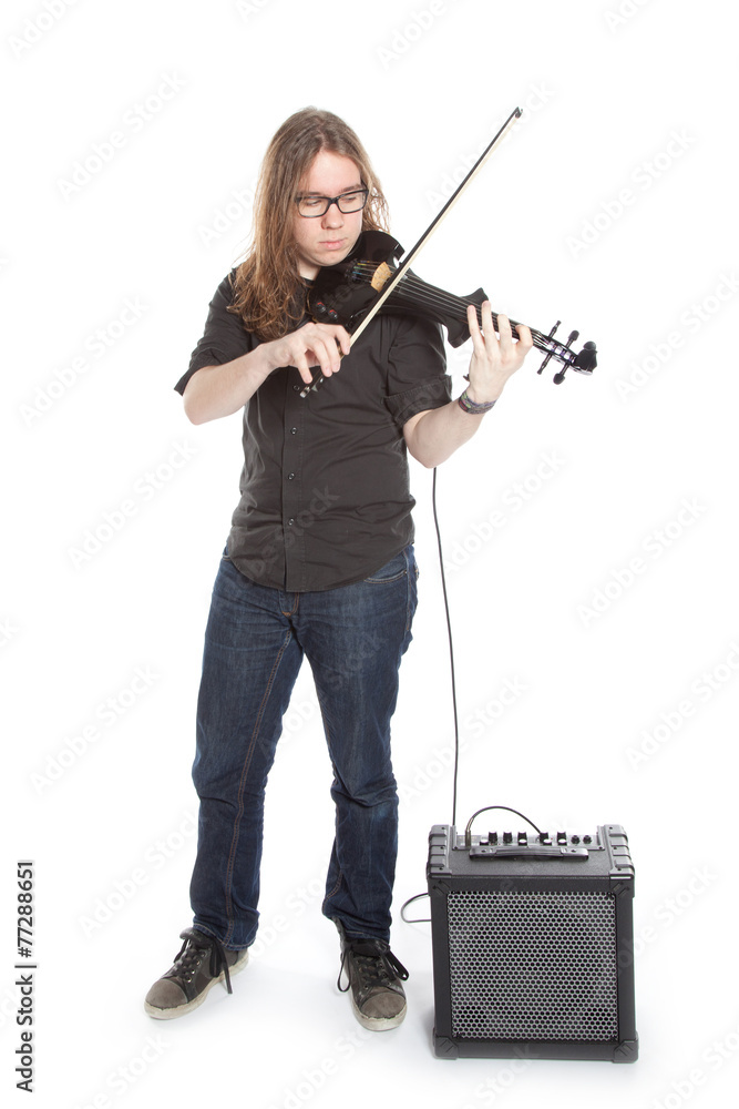 young man with glasses plays electric violin standing in studio young man with glasses plays electric violin standing in studio