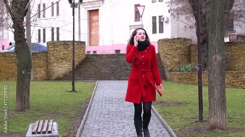 girl walking talking on her phone anxiously and worriedly photo