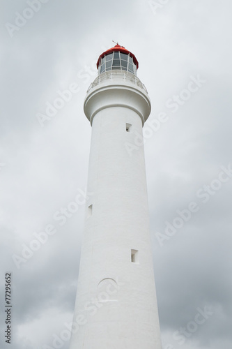 White lighthouse in front of storm clouds