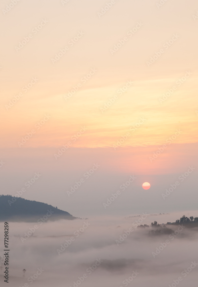 sunrise and mist-covered mountains