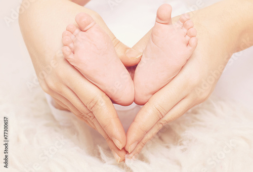 Baby feet in shape heart © rohappy