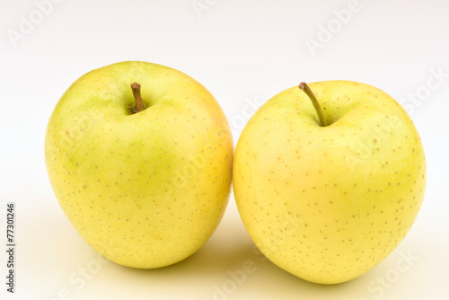 Ripe yellow apple on white background