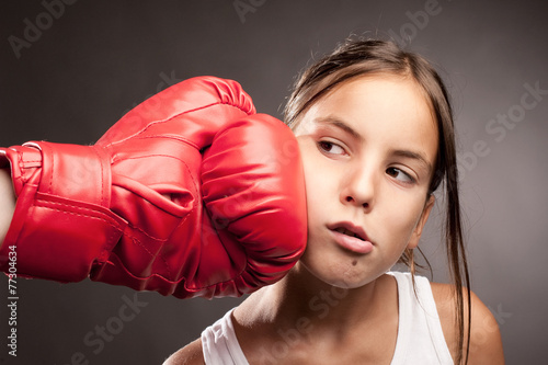 little girl and red boxing globe  hitting her face © xavier gallego morel