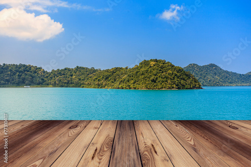 Wood floor and blue sea with island © tortoon