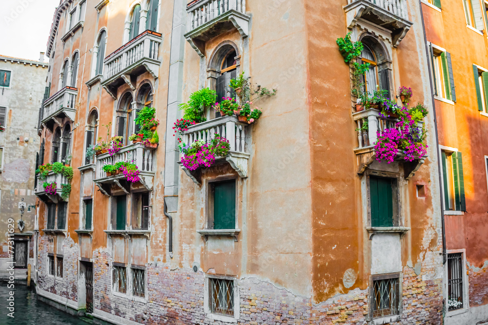 Residential house with balconies decorated with flowers, Venice