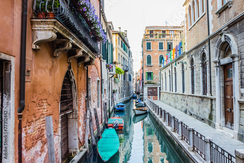 Street in Venice - water canal, boats and residential houses