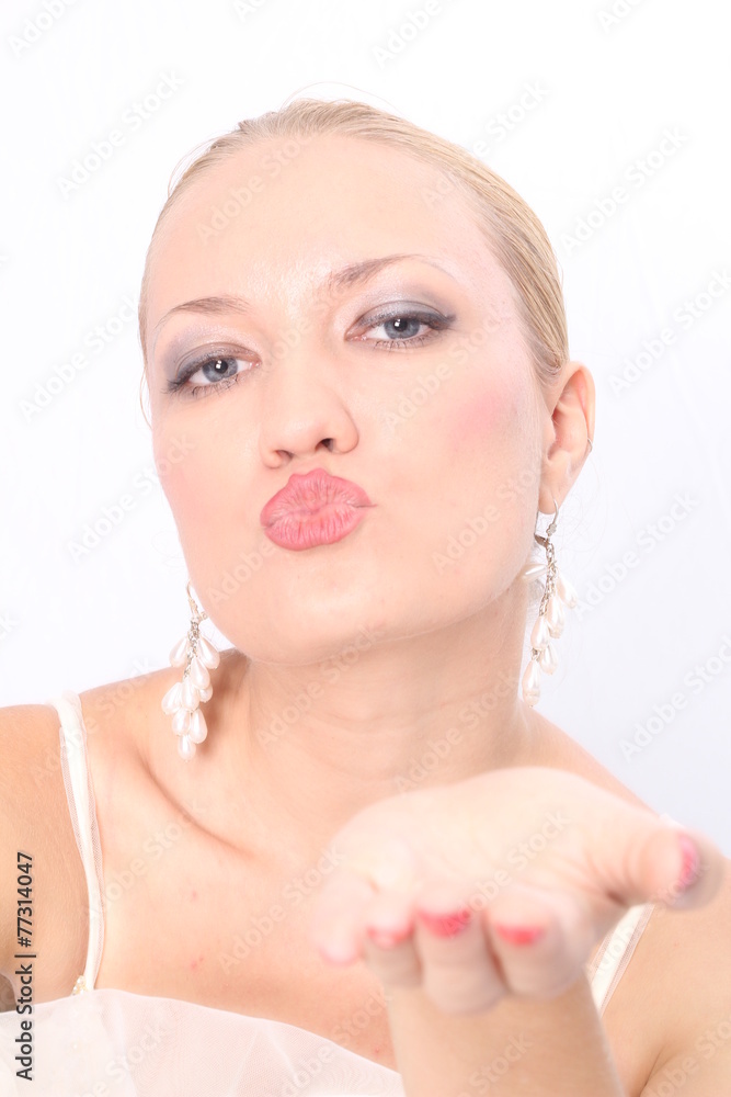 A portrait of a beautiful blonde bride, sending kiss