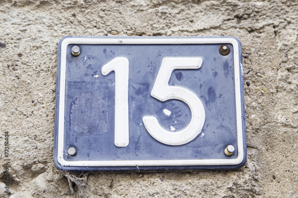 Number fifteen in a wall of a house Number fifteen in a wall of a house