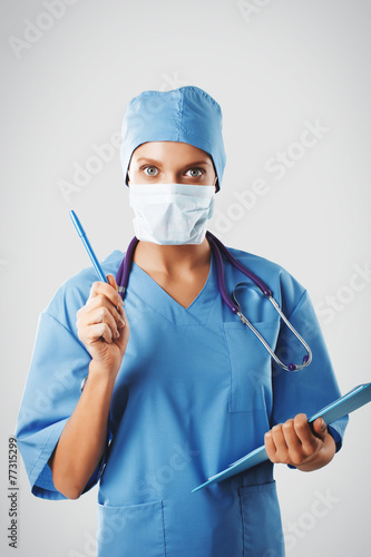  female doctor with stethoscope writing prescription