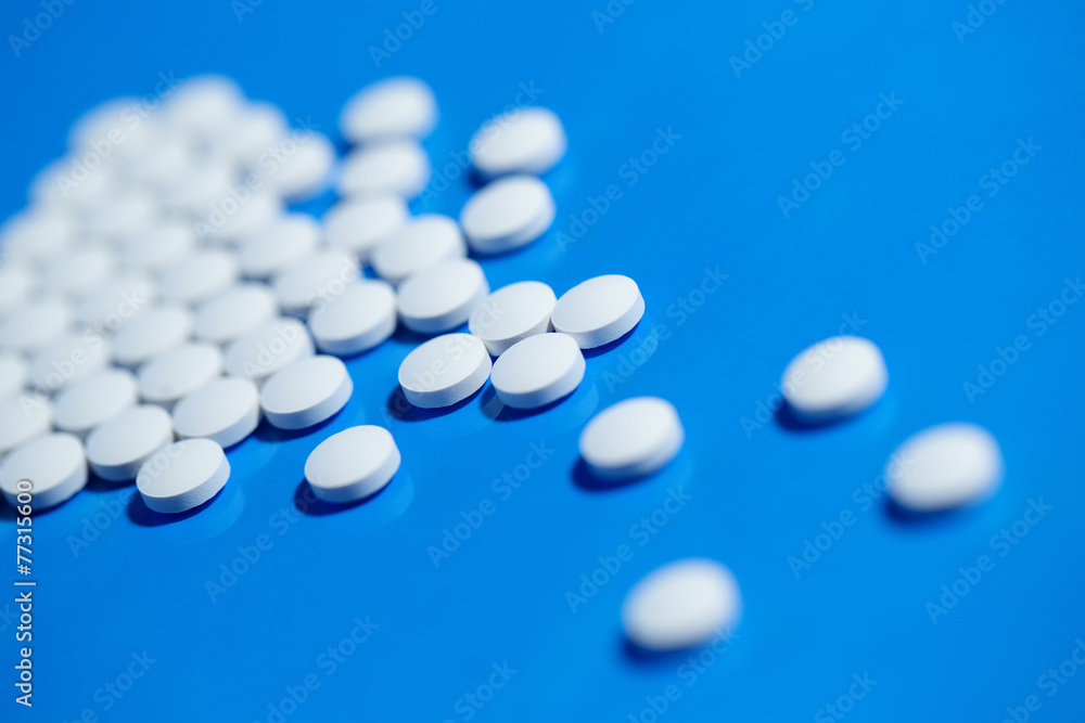pills. White medical pills on blue background pills. White medical pills on blue background