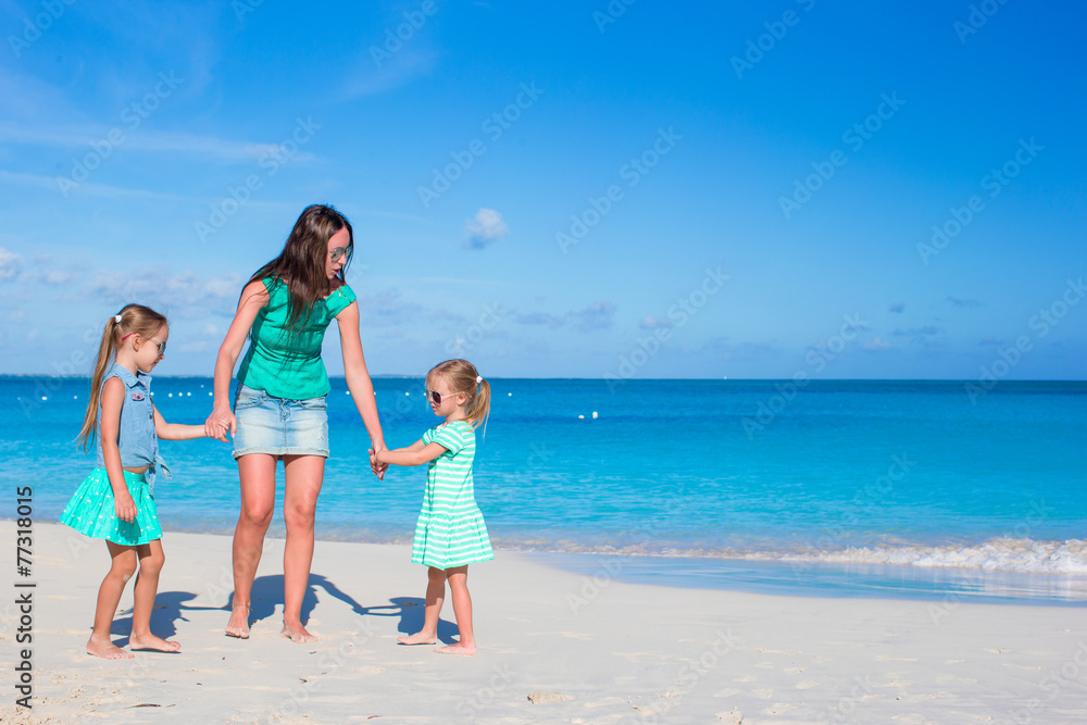 Young happy mother and little girl having fun during beach