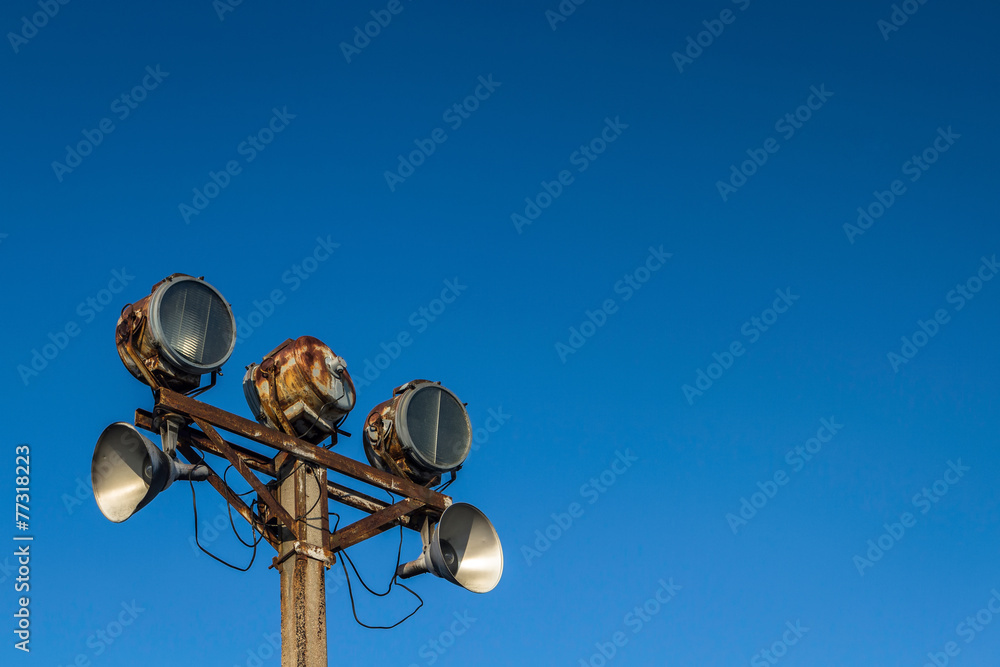 Old rusty lantern on a background of blue sky high