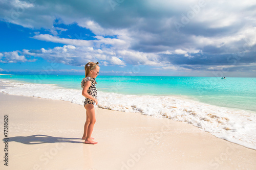 Adorable little girl on white beach during tropical vacation © travnikovstudio