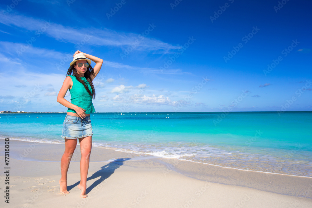 Young happy woman on beach during her summer vacation Young happy woman on beach during her summer vacation