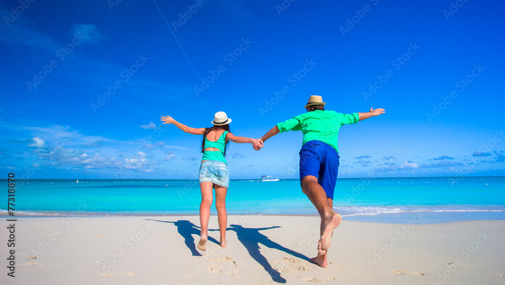 Young happy couple during tropical beach vacation