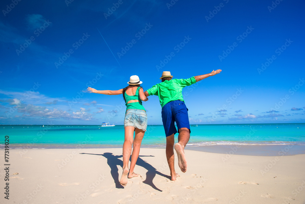 Young happy couple during tropical beach vacation Young happy couple during tropical beach vacation