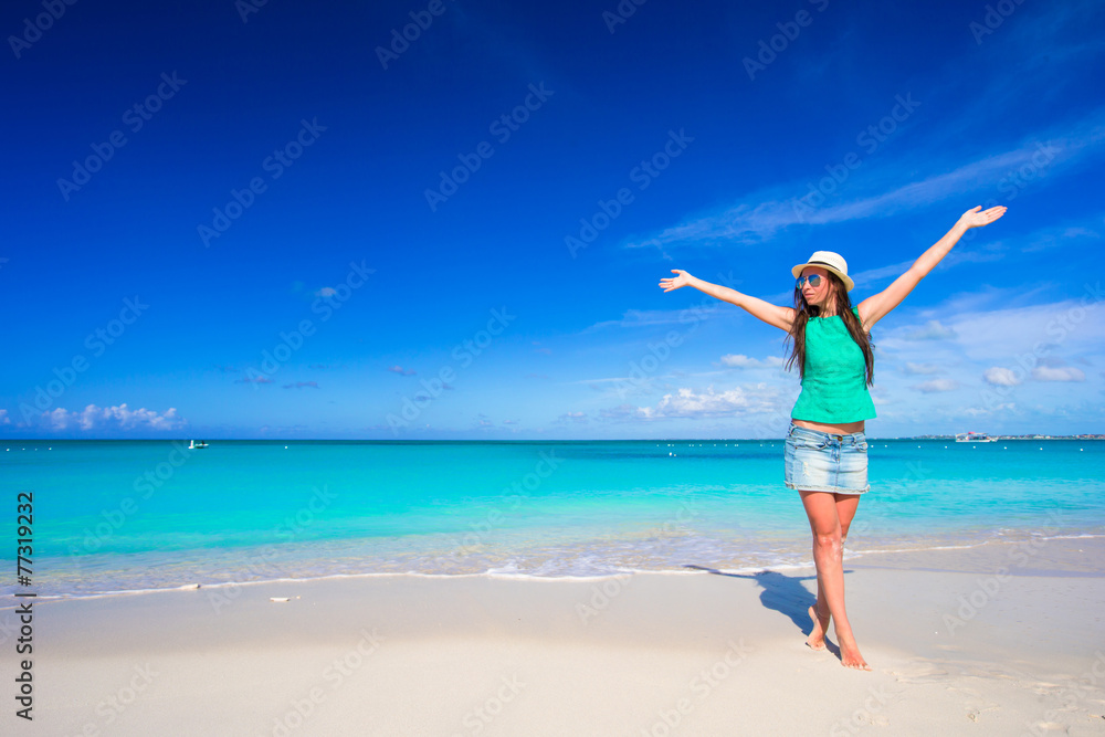 Young happy woman on beach during her summer vacation Young happy woman on beach during her summer vacation