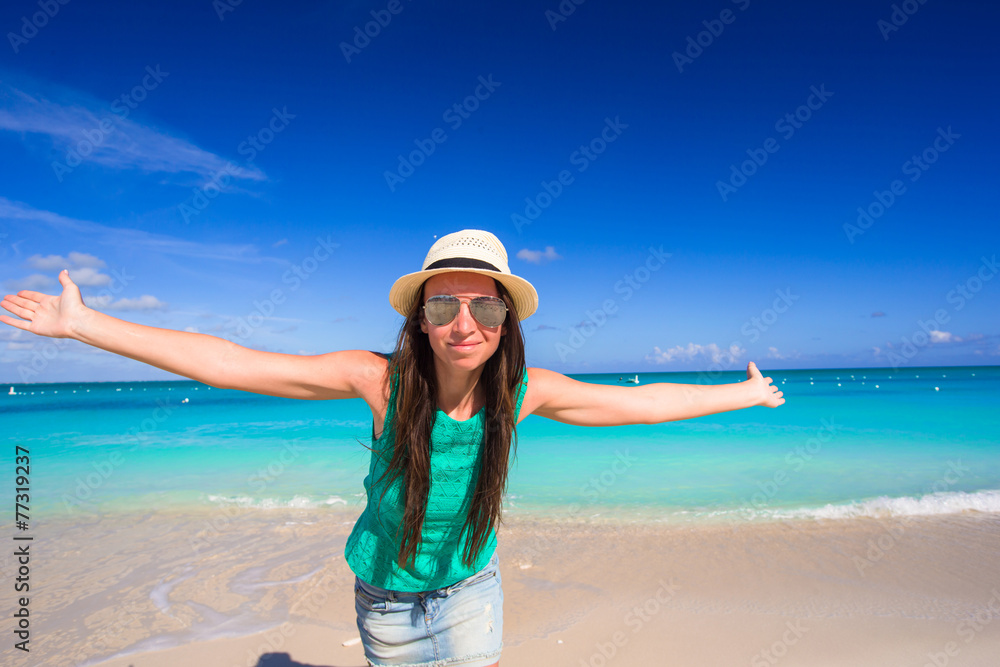 Young happy woman on beach during her summer vacation Young happy woman on beach during her summer vacation