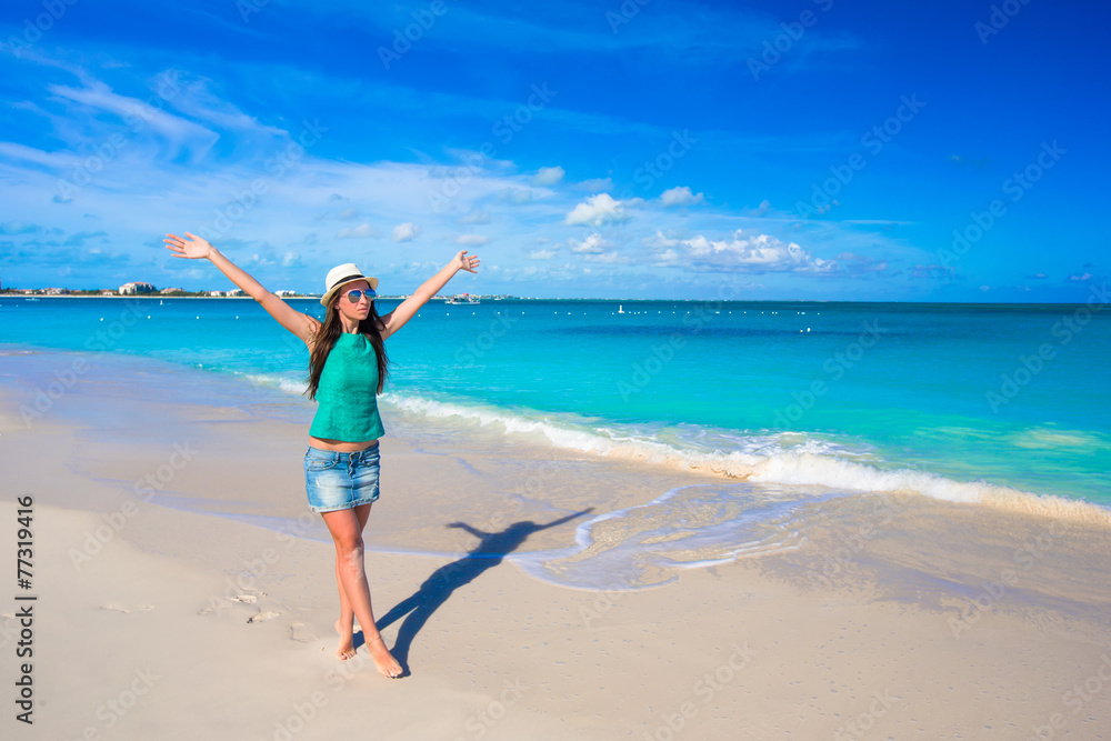 Young happy woman on beach during her summer vacation Young happy woman on beach during her summer vacation