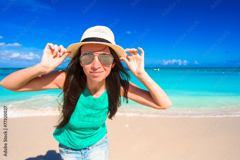 Young happy woman on beach during her summer vacation