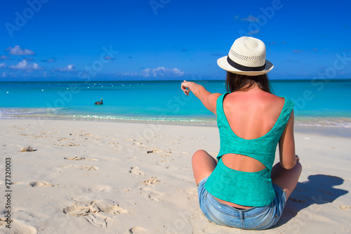 Young happy woman on beach during her summer vacation