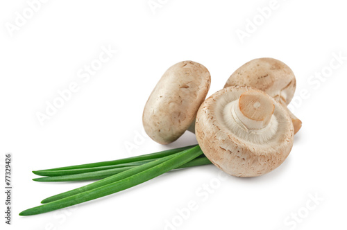 Three raw mushrooms and onion leaves