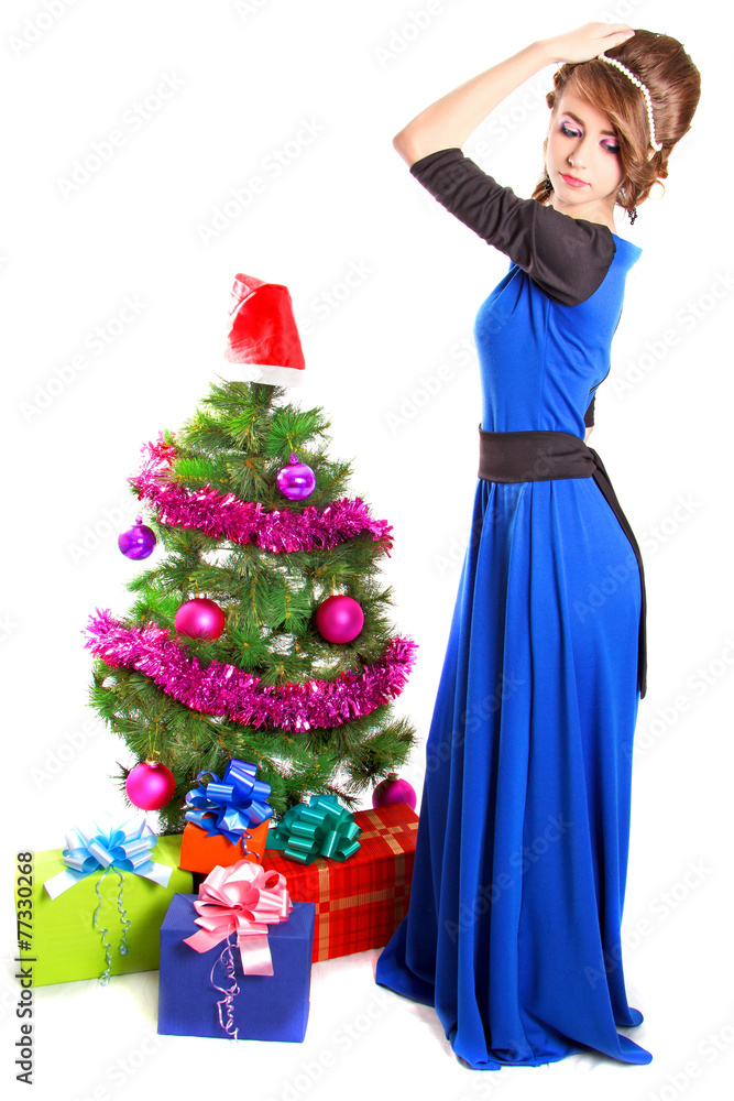 Portrait of a beautiful young woman near the Christmas tree