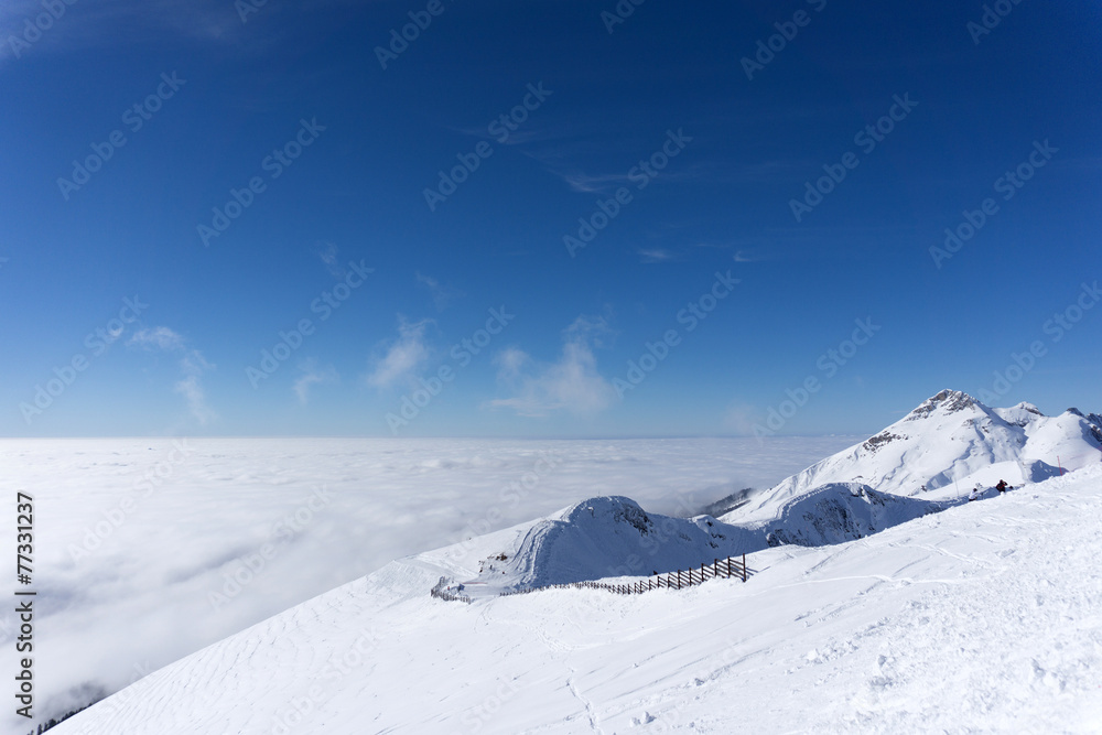 View on mountains and blue sky above clouds