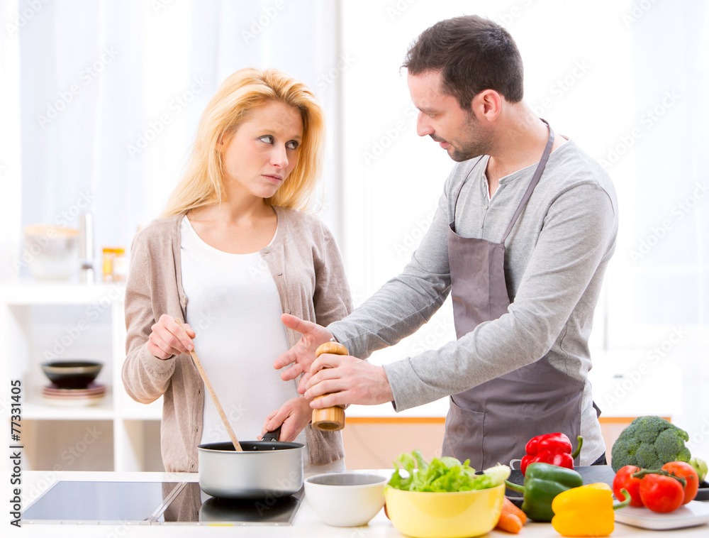 Young attractive couple having an argue while cooking Young attractive couple having an argue while cooking