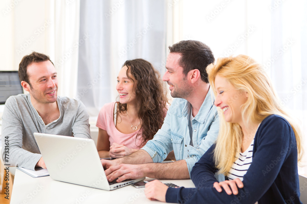 Group of 4 young attractive people working on a laptop Group of 4 young attractive people working on a laptop