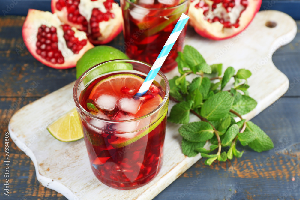 Pomegranate drink in glasses with slices of lime and mint Pomegranate drink in glasses with slices of lime and mint
