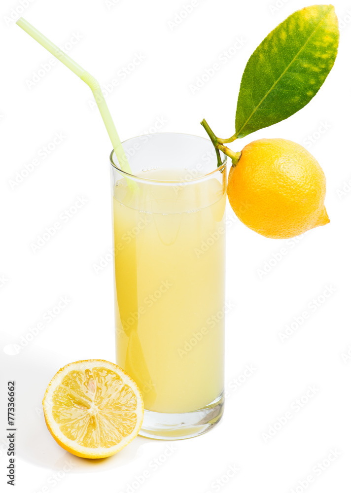 Glass of lemon juice and fruit with leaves Glass of lemon juice and fruit with leaves