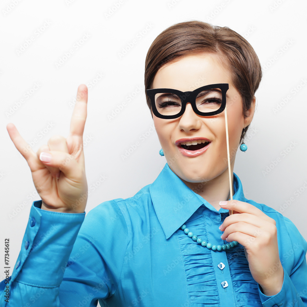 Playful young women holding a party glasses. Playful young women holding a party glasses.