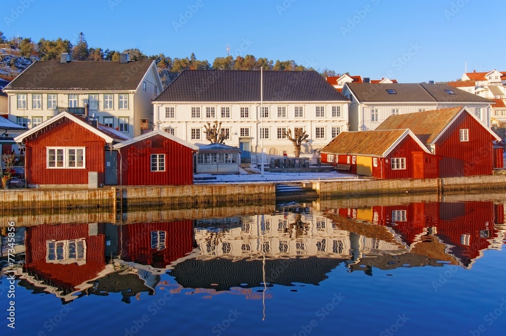 Obraz premium A double line of wooden buildings, white and red