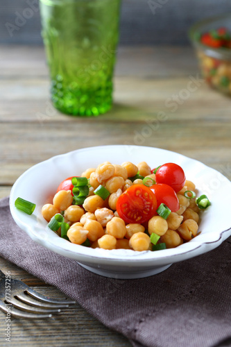 Delicious salad with boiled chickpeas and tomatoes