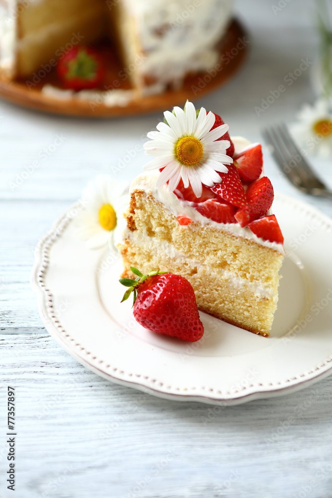 Slice of cake with strawberries on a white plate Slice of cake with strawberries on a white plate