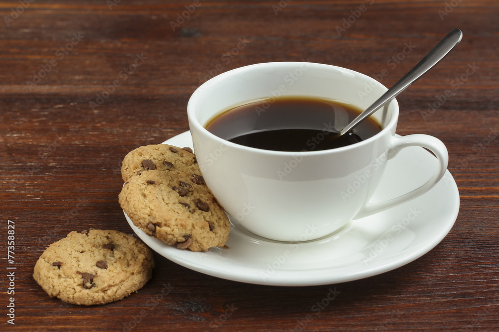 chocolate cookies and cup of hot coffee on old wooden table chocolate cookies and cup of hot coffee on old wooden table