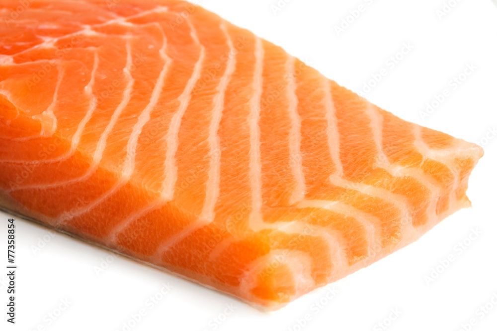 Raw salmon fillet on white.