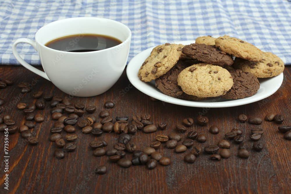 chocolate cookies and cup of hot coffee on old wooden table chocolate cookies and cup of hot coffee on old wooden table