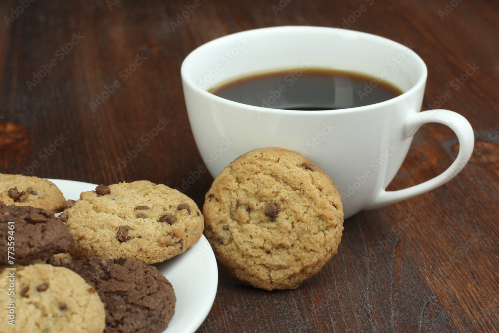 chocolate cookies and cup of hot coffee on old wooden table chocolate cookies and cup of hot coffee on old wooden table
